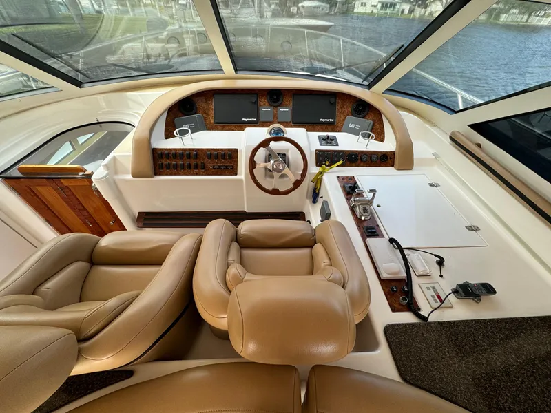 Slide: The Image of 2006 Neptunus 55 Cabrio yacht helm with leather seats and modern controls. - 32