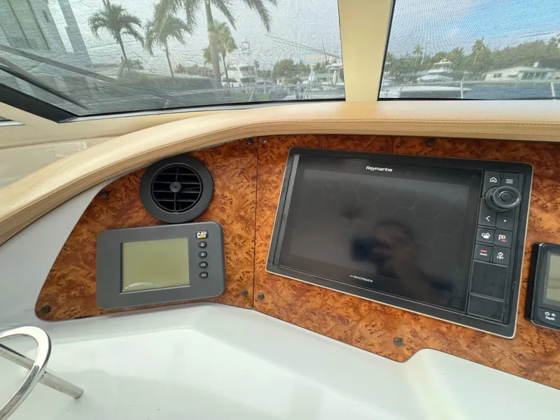 Slide: The Image of 2006 Neptunus 55 Cabrio yacht dashboard with navigation screens and controls. - 41