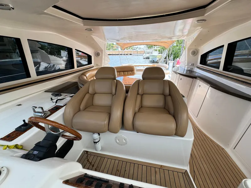 Slide: The Image of 2006 Neptunus 55 Cabrio yacht interior with tan leather seats and wooden accents. - 45
