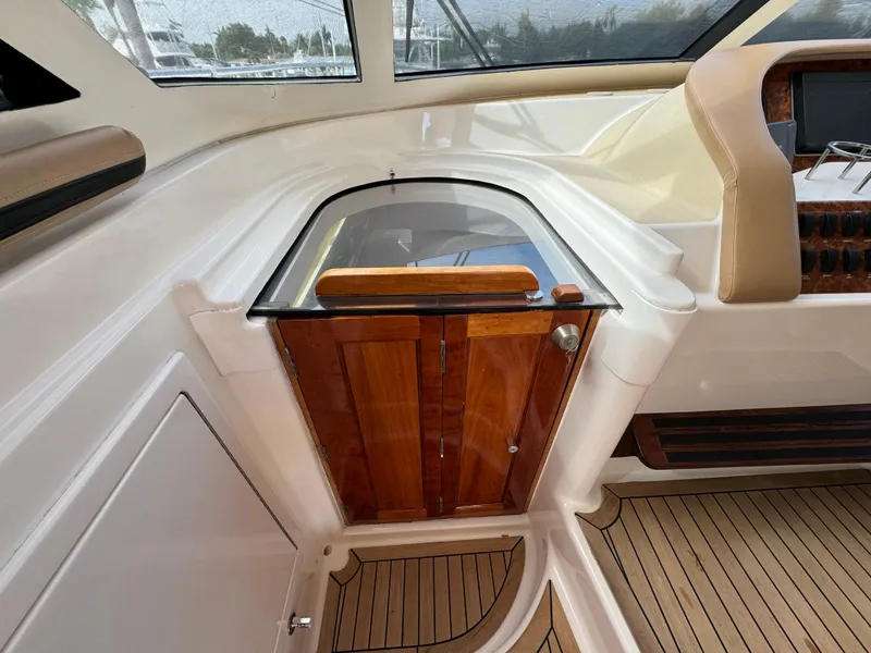 Slide: The Image of 2006 Neptunus 55 Cabrio yacht interior with wooden cabinetry and seating. - 46