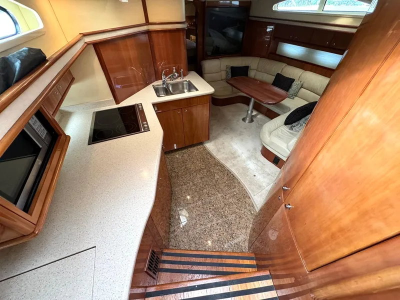 Slide: The Image of Interior of 2006 Neptunus 55 Cabrio yacht with kitchen and seating area. - 47