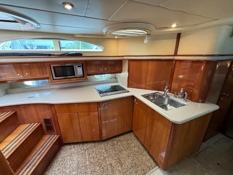 Slide: The Image of Luxurious kitchen area in a 2006 Neptunus 55 Cabrio yacht with wooden cabinetry. - 48