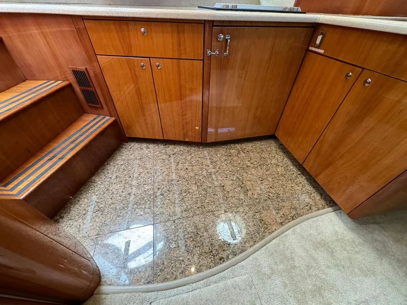 Slide: The Image of 2006 Neptunus 55 Cabrio yacht interior with wooden cabinets and granite flooring. - 49