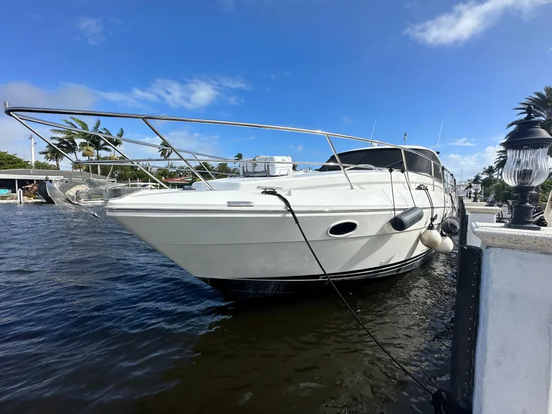 Slide: The Image of 2006 Neptunus 55 Cabrio yacht docked by the waterfront on a sunny day. - 6