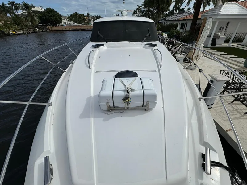 Slide: The Image of 2006 Neptunus 55 Cabrio yacht docked by waterfront homes. - 8