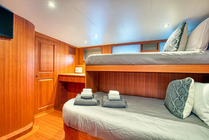 Slide: The Image of Luxurious 2025 Hampton 750 Endurance LRC yacht cabin with wooden interior and cozy bedding. - 13