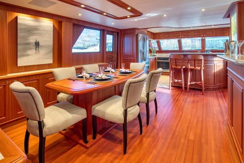 Slide: The Image of Luxurious dining area on 2025 Hampton 750 Endurance LRC yacht with elegant wood finishes. - 15