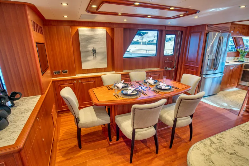 Slide: The Image of Luxurious dining area on 2025 Hampton 750 Endurance LRC yacht with elegant wood finishes. - 16