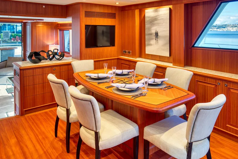 Slide: The Image of Luxurious dining area on 2025 Hampton 750 Endurance LRC yacht with elegant wood finish. - 18