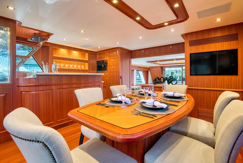 Slide: The Image of Luxurious dining area on 2025 Hampton 750 Endurance LRC yacht with elegant wood finish. - 19