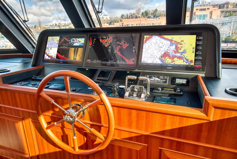 Slide: The Image of Helm of 2025 Hampton 750 Endurance LRC yacht with navigation screens and wooden steering wheel. - 30