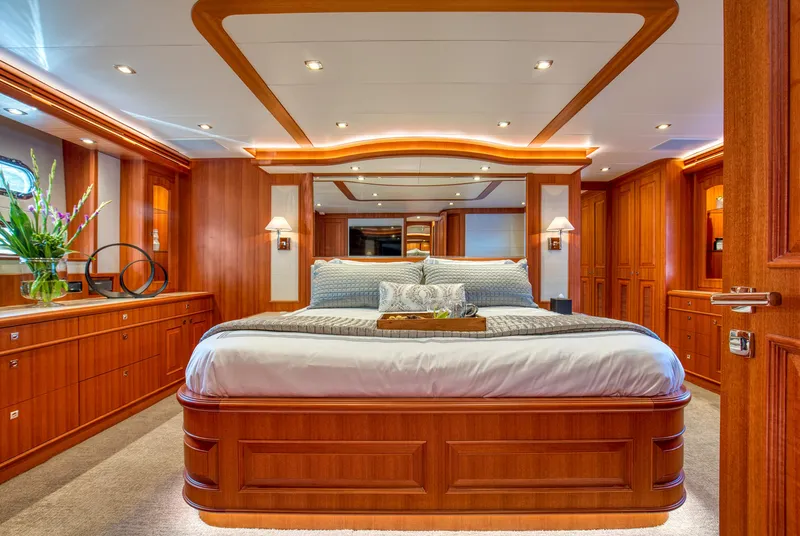 Slide: The Image of Luxurious bedroom interior of 2025 Hampton 750 Endurance LRC yacht with elegant wood finish. - 35