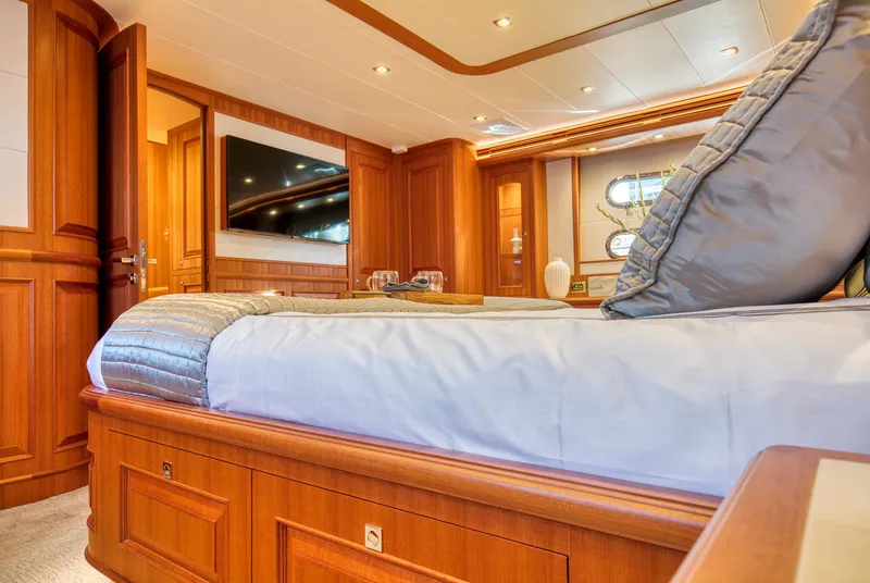 Slide: The Image of Luxurious bedroom interior of 2025 Hampton 750 Endurance LRC yacht, featuring elegant wood finishes. - 40