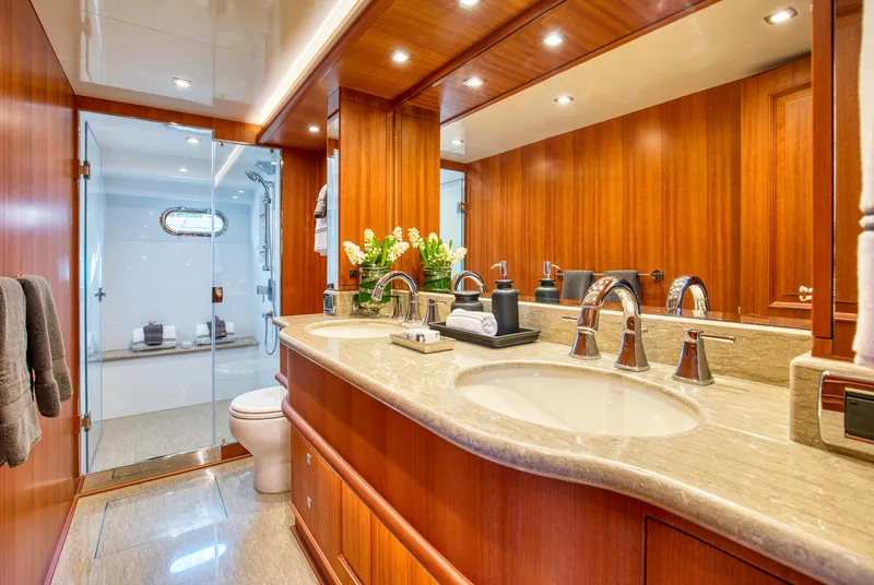 Slide: The Image of Luxurious bathroom in 2025 Hampton 750 Endurance LRC yacht with dual sinks and elegant wood finish. - 41