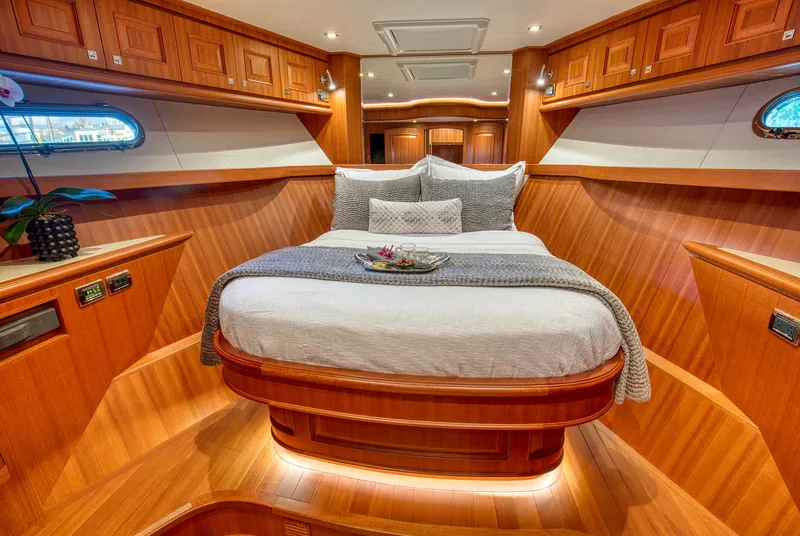 Slide: The Image of Luxurious 2025 Hampton 750 Endurance LRC yacht bedroom with elegant wood finish and cozy bedding. - 48