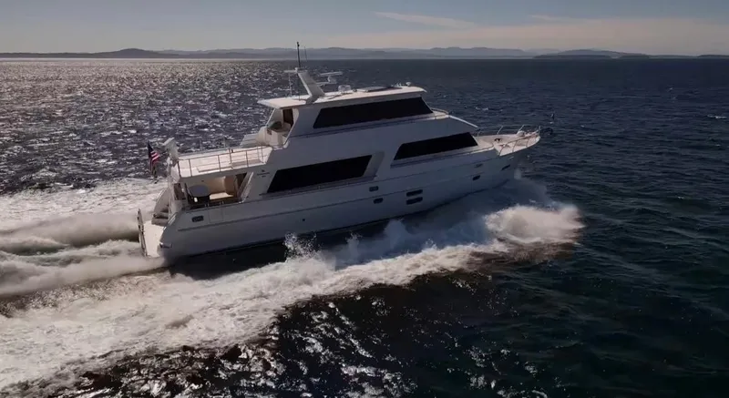 Slide: The Image of 2025 Hampton 750 Endurance LRC yacht cruising on open water. - 5