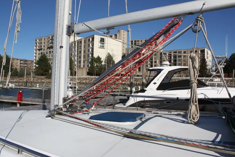 Slide: The Image of 1996 Catalina 34 MkII sailboat docked, with urban buildings in the background. - 14
