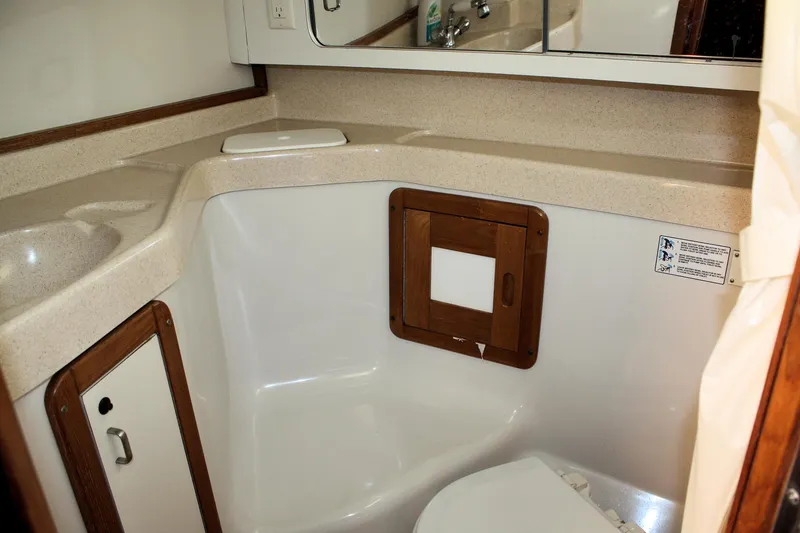 Slide: The Image of 1996 Catalina 34 MkII yacht bathroom with sink, mirror, and storage cabinet. - 17
