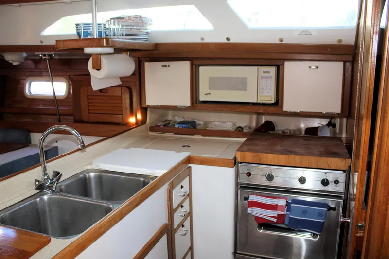 Slide: The Image of Interior of 1996 Catalina 34 MkII yacht kitchen with sink, stove, and microwave. - 19