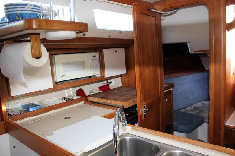 Slide: The Image of Interior of 1996 Catalina 34 MkII sailboat with kitchen and seating area. - 21