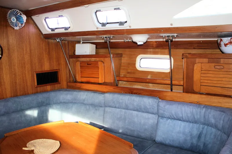 Slide: The Image of Interior of 1996 Catalina 34 MkII sailboat with wooden cabinetry and blue seating. - 23