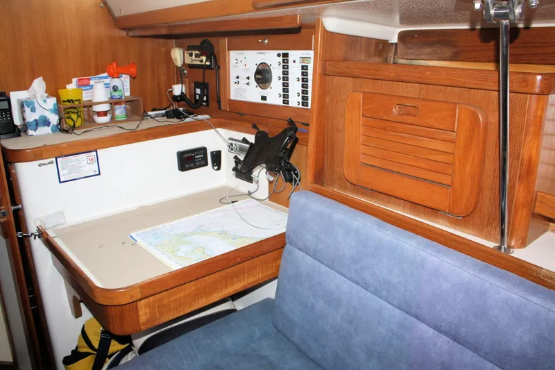Slide: The Image of Navigation station inside a 1996 Catalina 34 MkII sailboat, featuring a chart table and control panel. - 25