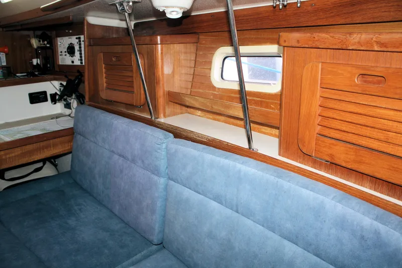 Slide: The Image of Interior of 1996 Catalina 34 MkII sailboat with blue seating and wooden cabinetry. - 26