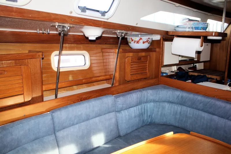 Slide: The Image of Interior of 1996 Catalina 34 MkII sailboat with blue seating and wooden cabinetry. - 27