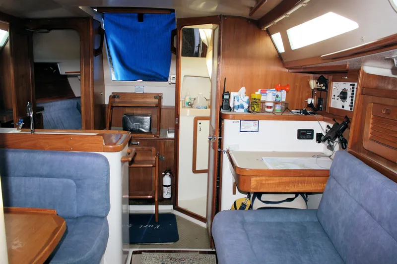 Slide: The Image of Interior of a 1996 Catalina 34 MkII sailboat with blue seating and wooden cabinetry. - 28