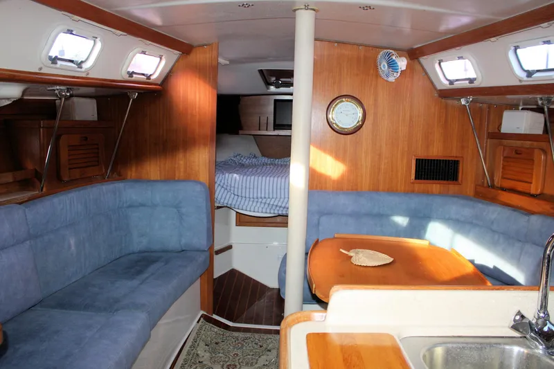 Slide: The Image of Interior of a 1996 Catalina 34 MkII sailboat with cozy seating and wooden finishes. - 31