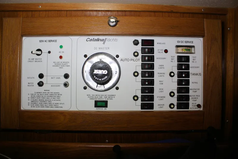 Slide: The Image of Control panel of a 1996 Catalina 34 MkII sailboat with various switches and indicators. - 32