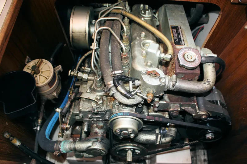 Slide: The Image of Engine of a 1996 Catalina 34 MkII sailboat, showcasing mechanical components and hoses. - 34