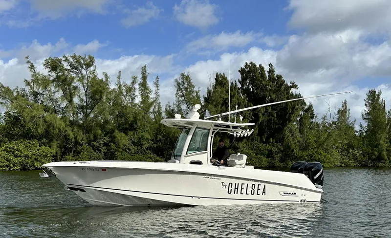The Image of 2014 Boston Whaler 280 Outrage boat named Chelsea cruising on a scenic waterway. - 0