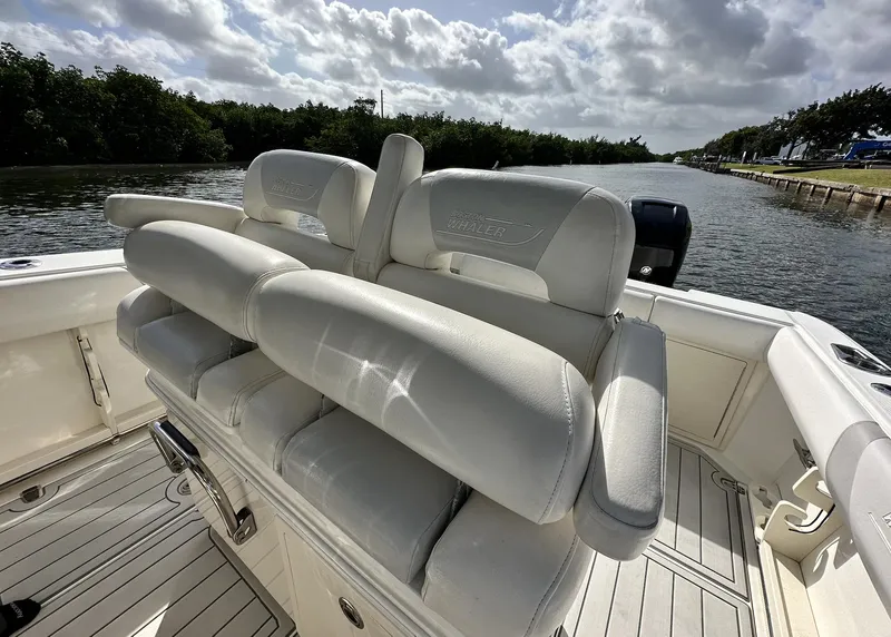 Slide: The Image of 2014 Boston Whaler 280 Outrage boat interior with cushioned seating. - 14