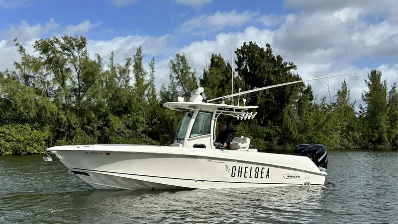 Slide: The Image of 2014 Boston Whaler 280 Outrage boat cruising on a scenic waterway. - 2