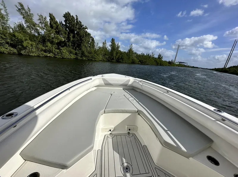 Slide: The Image of 2014 Boston Whaler 280 Outrage boat cruising on a scenic river. - 21