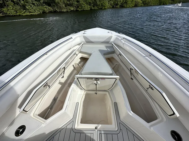 Slide: The Image of 2014 Boston Whaler 280 Outrage boat interior with storage compartments on a lake. - 22