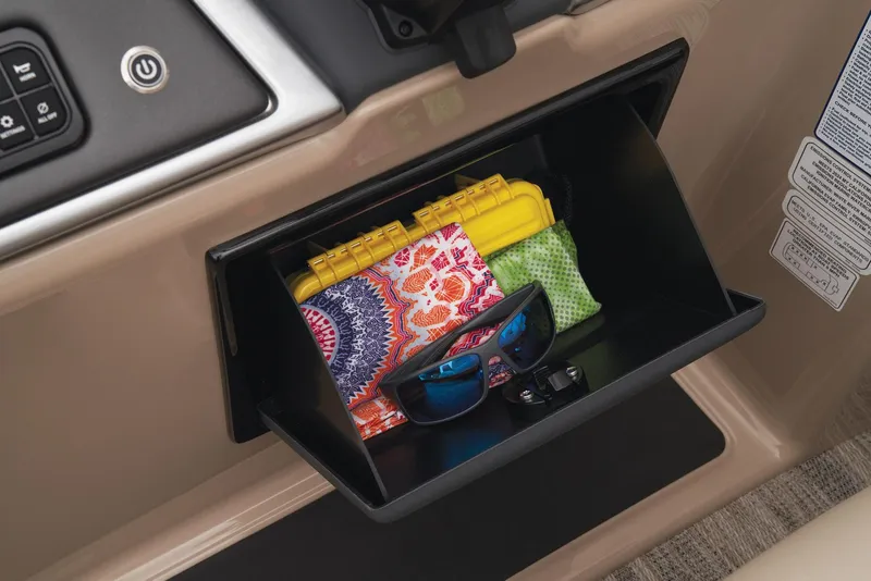 Slide: The Image of Storage compartment in 2024 Ranger Reata 220C with sunglasses, colorful pouch, and yellow case. - 36