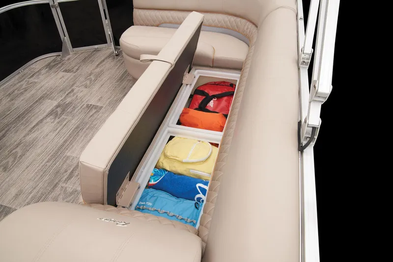 Slide: The Image of 2024 Ranger Reata 220C boat interior storage compartment with life jackets and towels. - 40