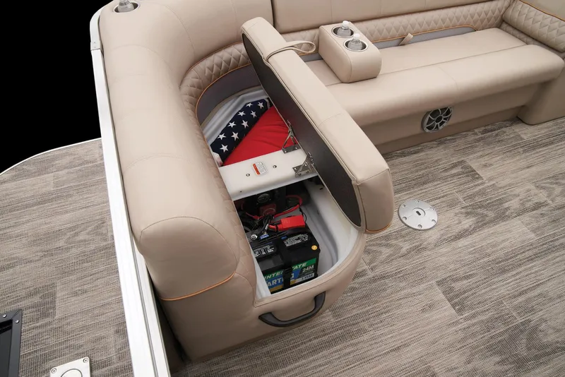 Slide: The Image of 2024 Ranger Reata 220C boat interior storage compartment with battery and American flag. - 41
