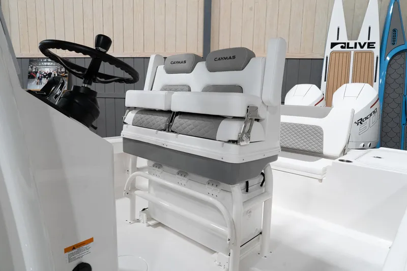 Slide: The Image of 2024 Caymas 281 HB boat interior with dual seats and steering wheel. - 11