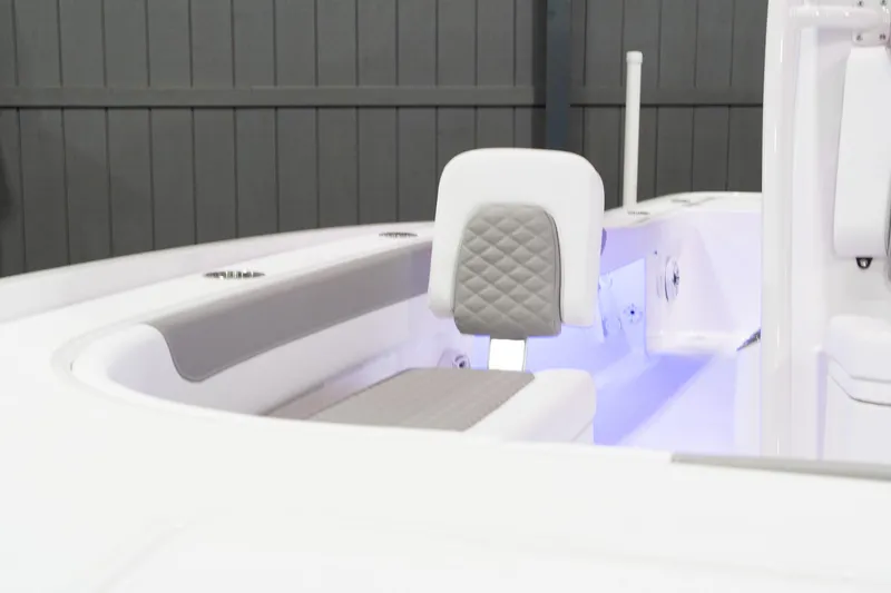 Slide: The Image of 2024 Caymas 281 HB boat interior with cushioned seating and LED lighting. - 16