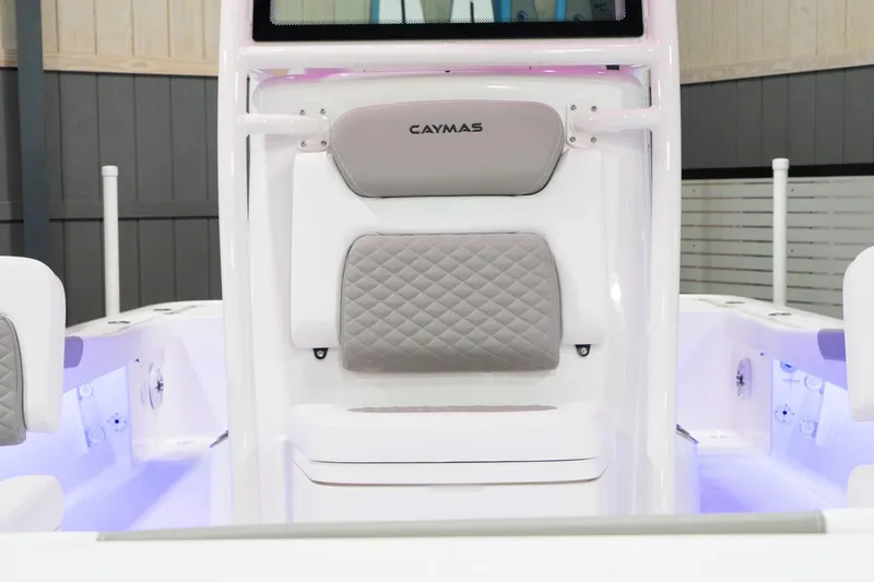 Slide: The Image of 2024 Caymas 281 HB boat interior with cushioned seating and ambient lighting. - 18