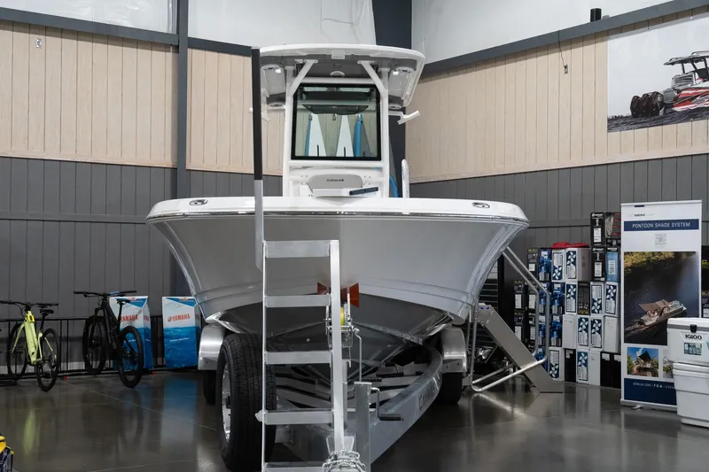 Slide: The Image of 2024 Caymas 281 HB boat displayed indoors on a trailer. - 2