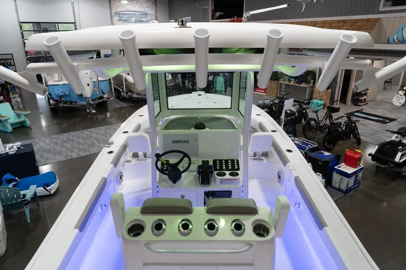 Slide: The Image of 2024 Caymas 281 HB boat interior with illuminated console and rod holders. - 20