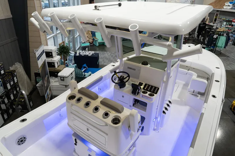 Slide: The Image of 2024 Caymas 281 HB boat interior with illuminated deck and fishing rod holders. - 21