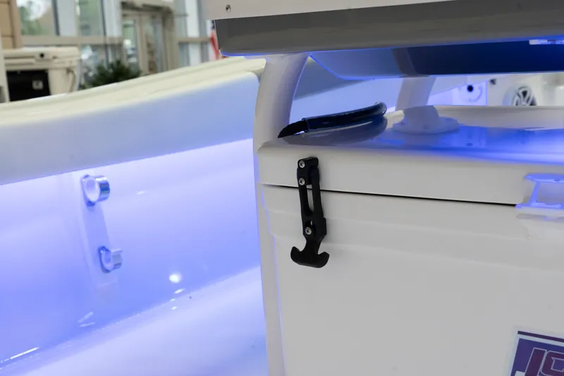 Slide: The Image of 2024 Caymas 281 HB boat interior with illuminated storage compartment. - 23