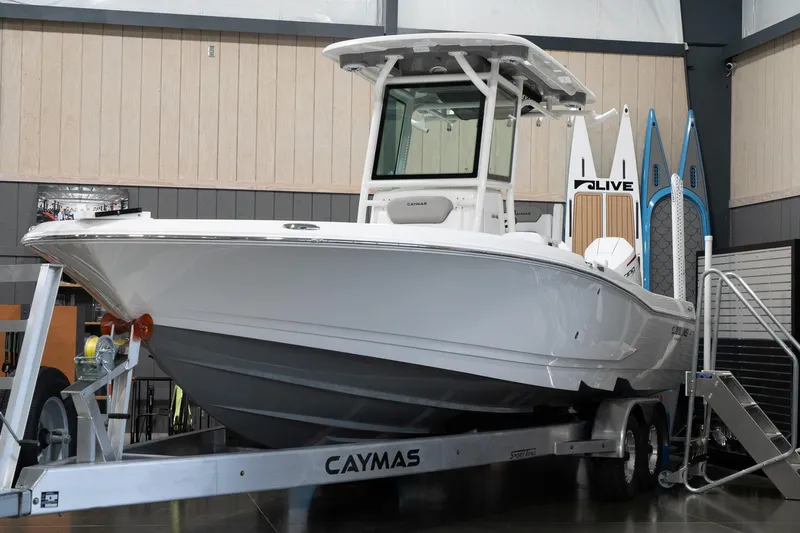 Slide: The Image of 2024 Caymas 281 HB boat on trailer in showroom. - 3