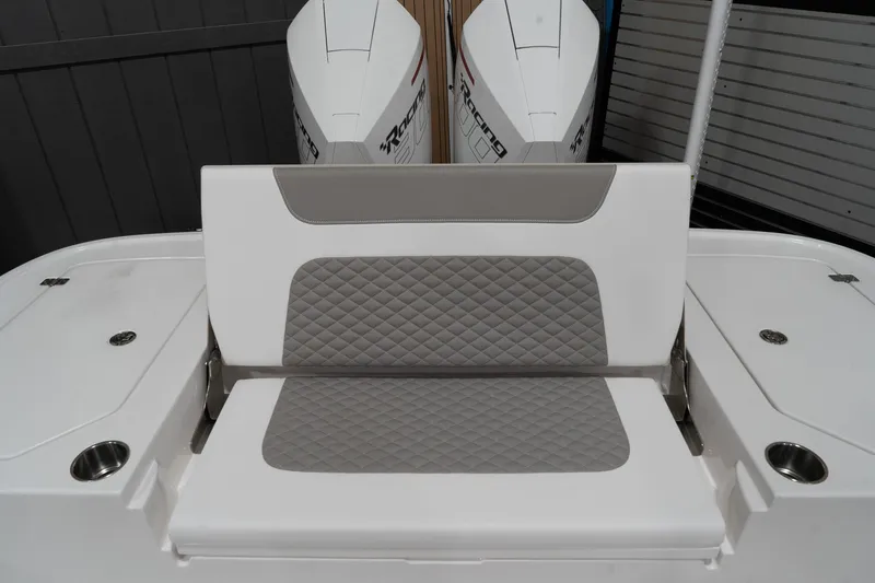 Slide: The Image of 2024 Caymas 281 HB boat with cushioned seating and dual outboard motors. - 5
