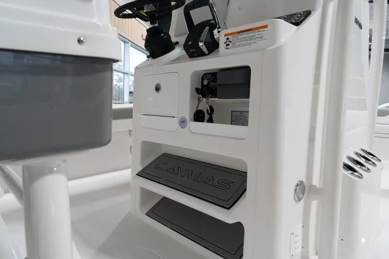 Slide: The Image of 2024 Caymas 281 HB boat console with storage compartments and steering wheel. - 7